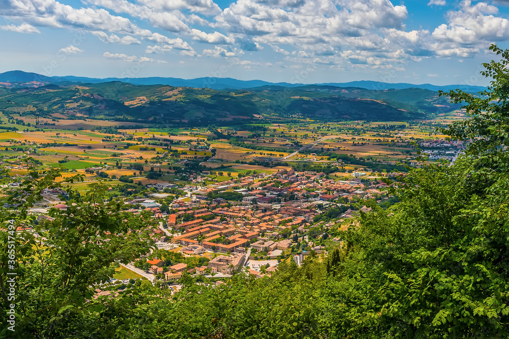 A view from the top of the Mount Ingino over the city of Gubbio, Italy towards the Apennine mountains in summer