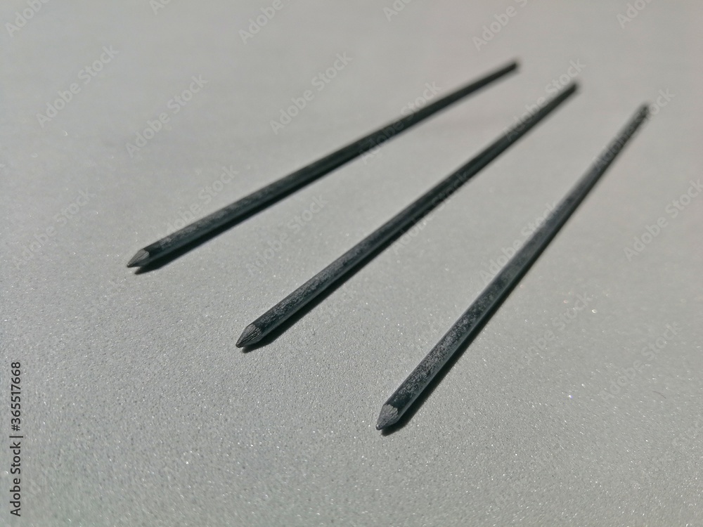 Graphite spare for mechanical pencils laid on a gray place Graphite spare for mechanical pencils laid on a gray place