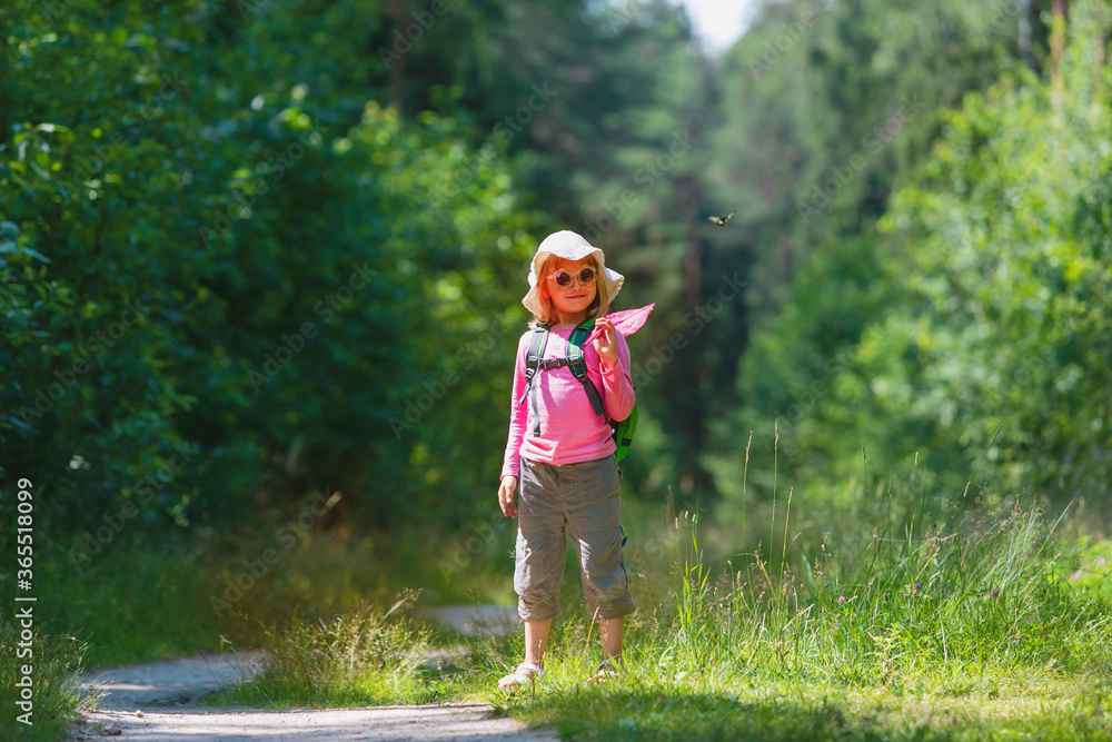 little girl ready to catch butterflies in summer nature