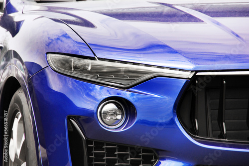 Part of a blue luxury car. Car headlights. Luxury Headlights © Stasiuk