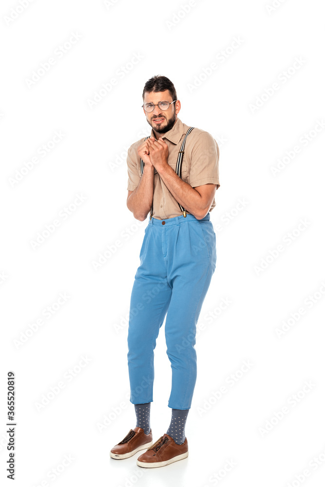 Scared nerd in suspenders looking at camera on white background Scared nerd in suspenders looking at camera on white background