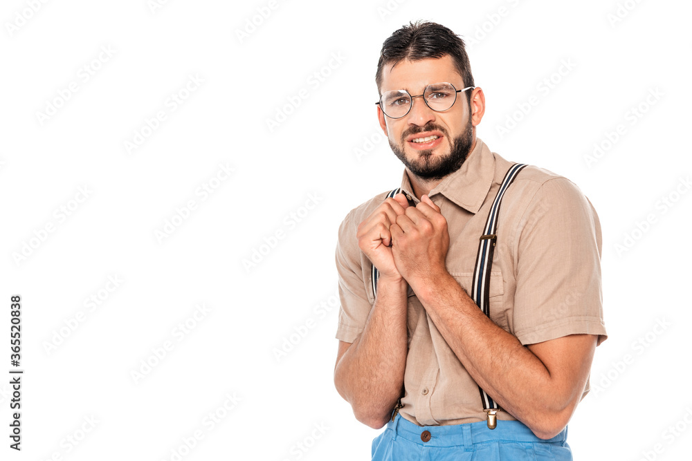Scared nerd in suspenders and eyeglasses looking at camera isolated on white Scared nerd in suspenders and eyeglasses looking at camera isolated on white