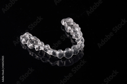 Transparent invisible dental aligners or braces aplicable for an orthodontic dental treatment photo