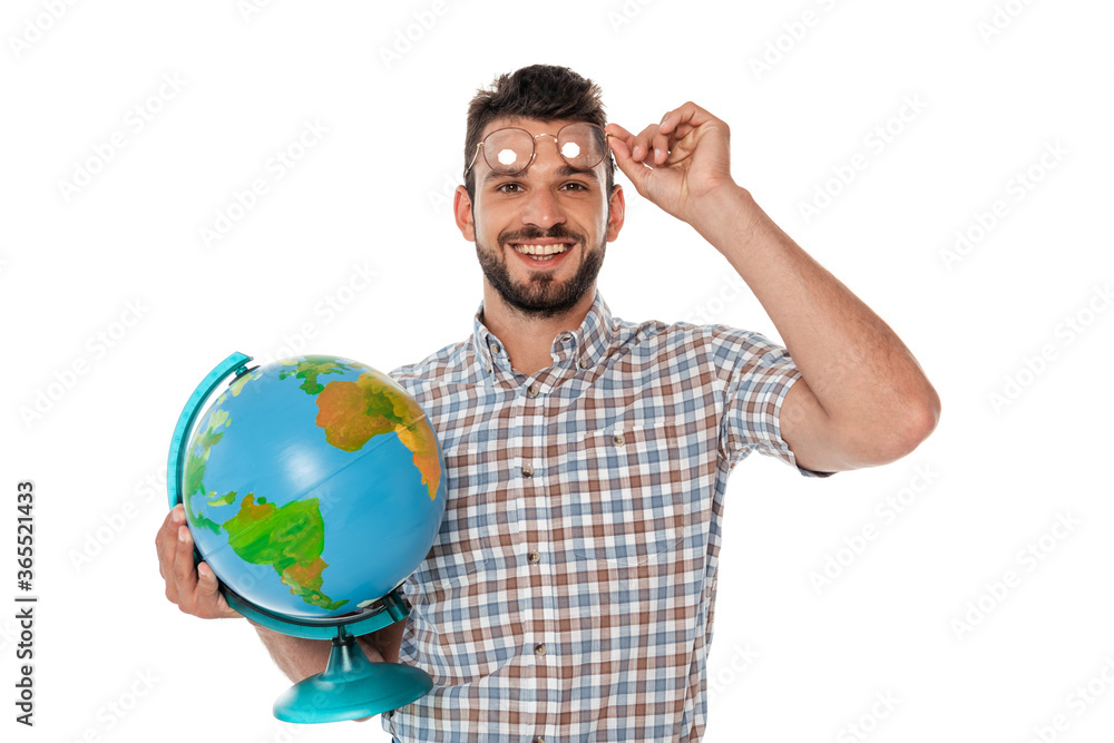 Smiling nerd holding eyeglasses and globe while looking at camera isolated on white Smiling nerd holding eyeglasses and globe while looking at camera isolated on white