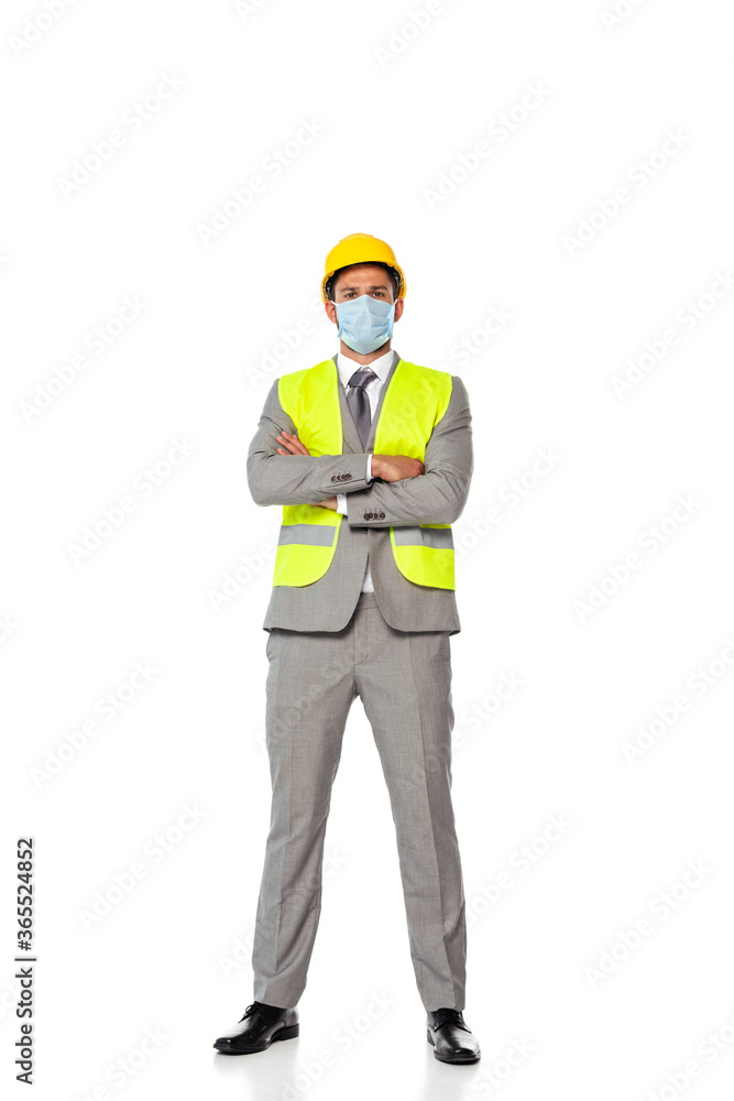 Engineer in medical mask with crossed arms looking at camera on white background Engineer in medical mask with crossed arms looking at camera on white background
