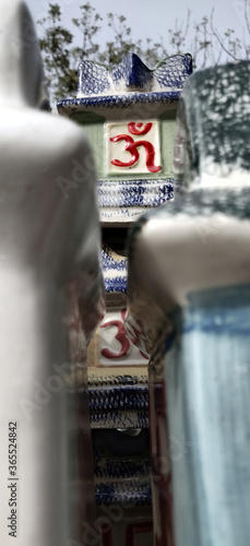 Stack of garden porcelain pots with aum written in red