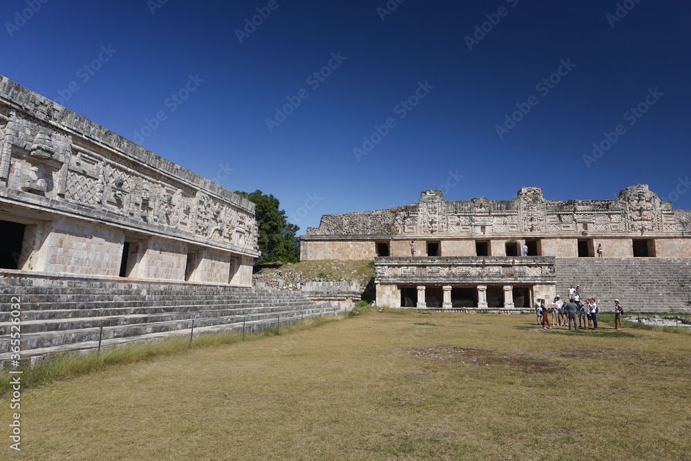 Uxmal, Mexico: Tourists visiting the Mesoamerican ball court at the ancient Mayan ruins of Uxmal.