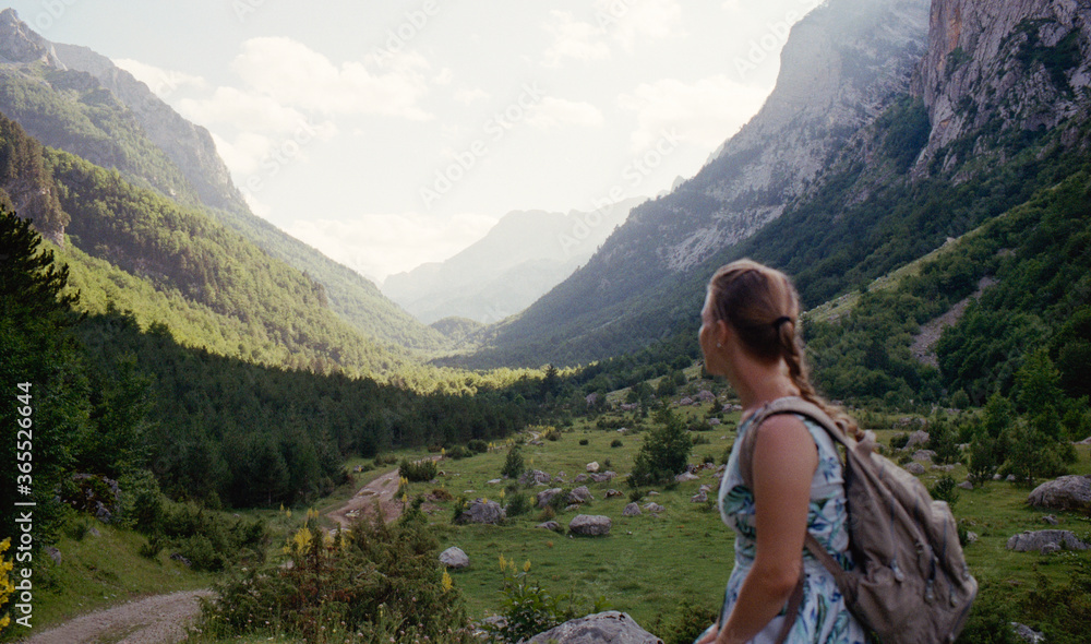 Young Caucasian woman in the mountains in Durmitor National Park in Montenegro. Real grain scanned film.