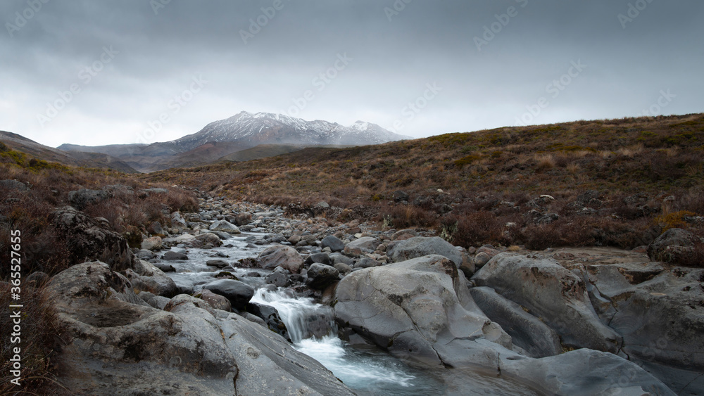 Obraz premium Mahuia river with Mt Ruapehu in the distance in the Taranaki Falls track in Tongariro National Park