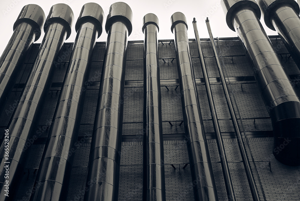 ventilation pipes and black brick wall of tallinn building for dark background or wallpaper ventilation pipes and black brick wall of tallinn building for dark background or wallpaper