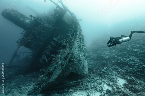 scuba diver in the sea exploring an old wreck  photo