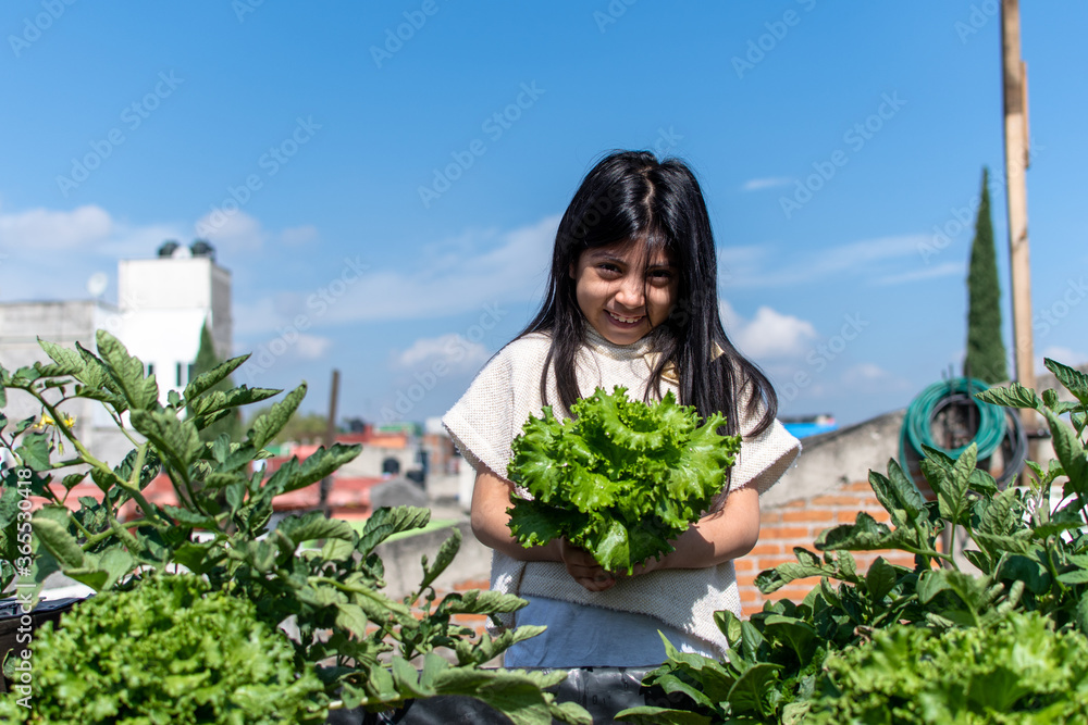 girl with lettuce on her hands