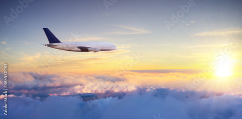 Commercial airplane flying above clouds