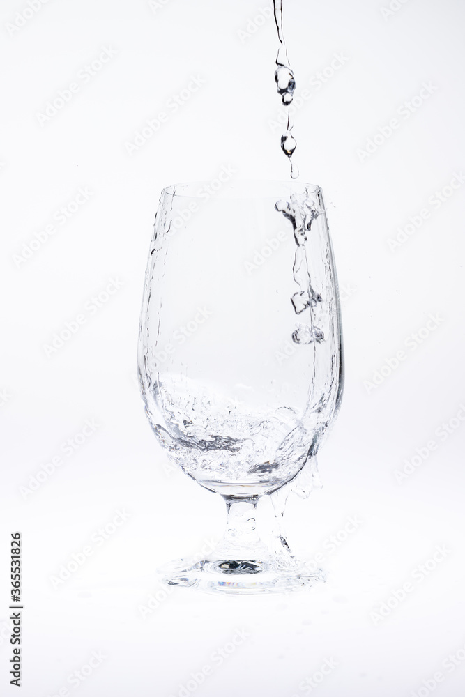 Pour water in glass isolated on white background. Pour water in glass isolated on white background.