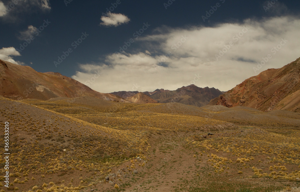Golden valley. Panorama view of the rocky mountains, hills and yellow grassland in autumn. Golden valley. Panorama view of the rocky mountains, hills and yellow grassland in autumn.