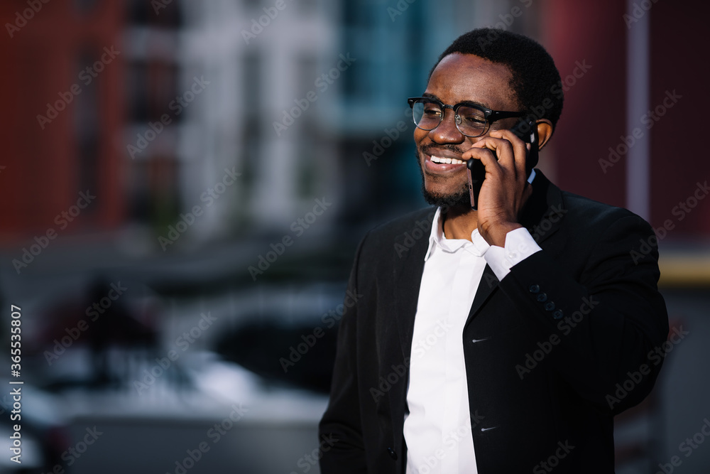 cheerful young man talking on a cell phone cheerful young man talking on a cell phone