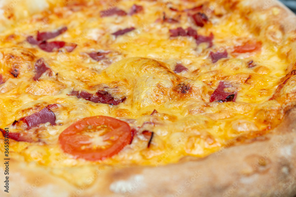 Homemade pizza with cheese and ham close up Homemade pizza with cheese and ham close up