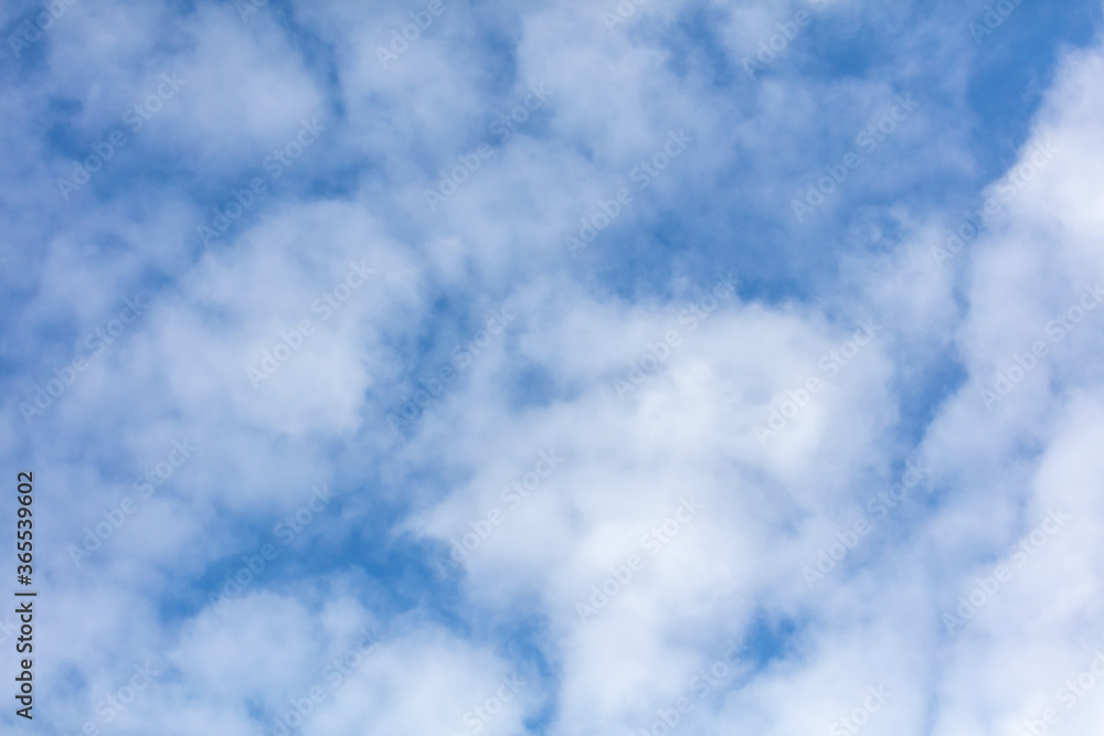 Obraz premium White clouds on a blue sky as background