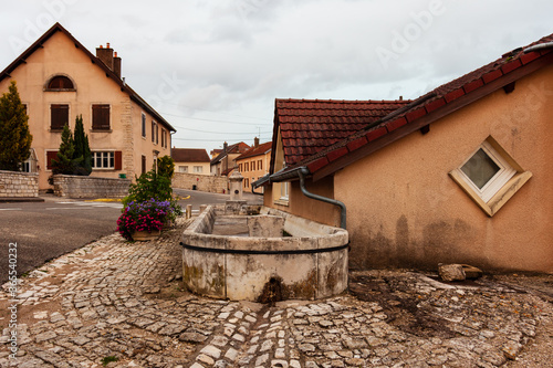 Empty paving street road in town Saint-Vit. Nice small window in house wall. France, Europe.
