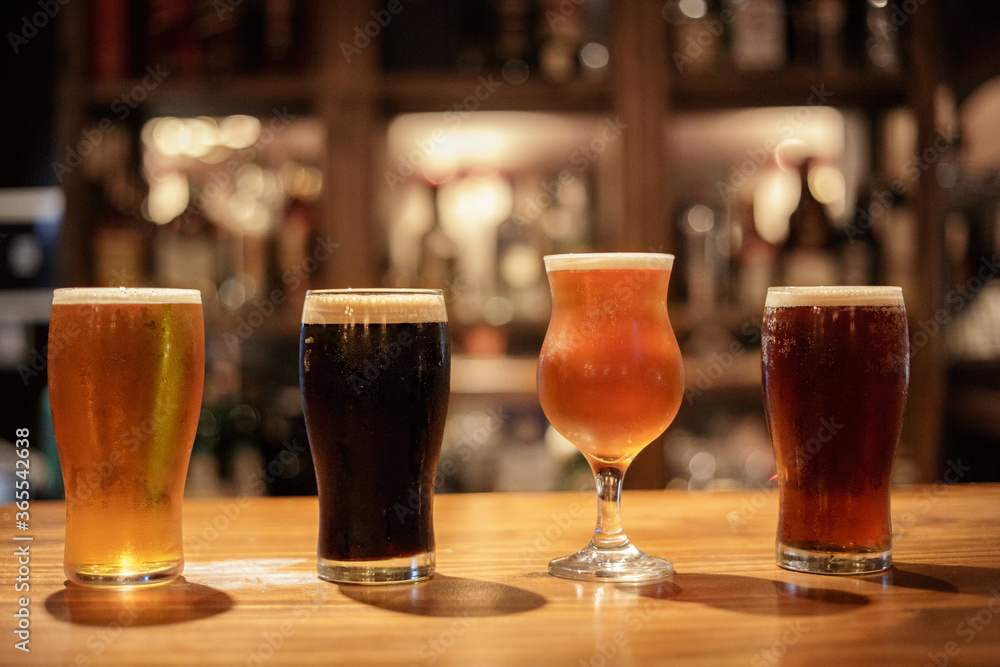 glasses whit diferent styles of beer on the pub table glasses whit diferent styles of beer on the pub table