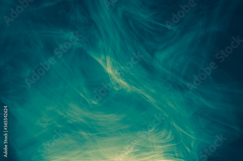 Clouds of colored flowing smoke on a dark background.
