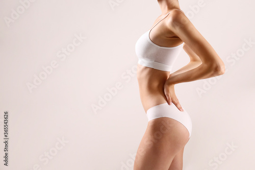 Cropped image of a sporty female in white bra and panties.