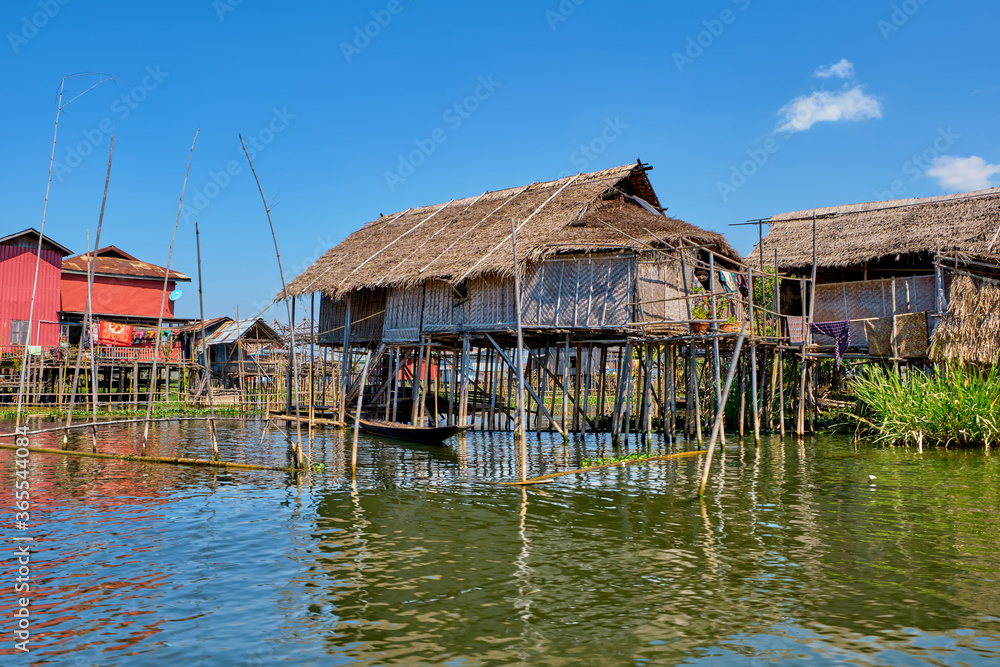 Wooden floating houses on Inle Lake in Shan, Myanmar, view from boat Wooden floating houses on Inle Lake in Shan, Myanmar, view from boat