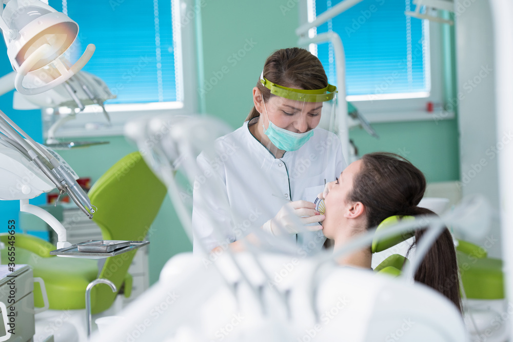 Dentist and patient in dentist office Dentist and patient in dentist office