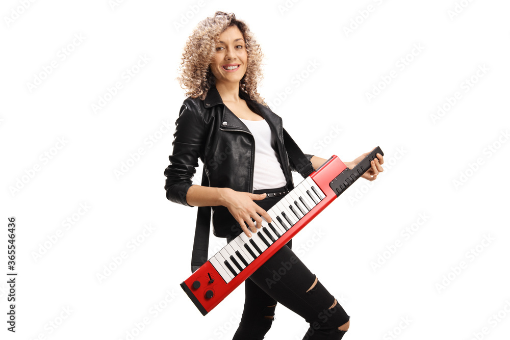 Female musician with a curly hair plaing on a red keytar Female musician with a curly hair plaing on a red keytar
