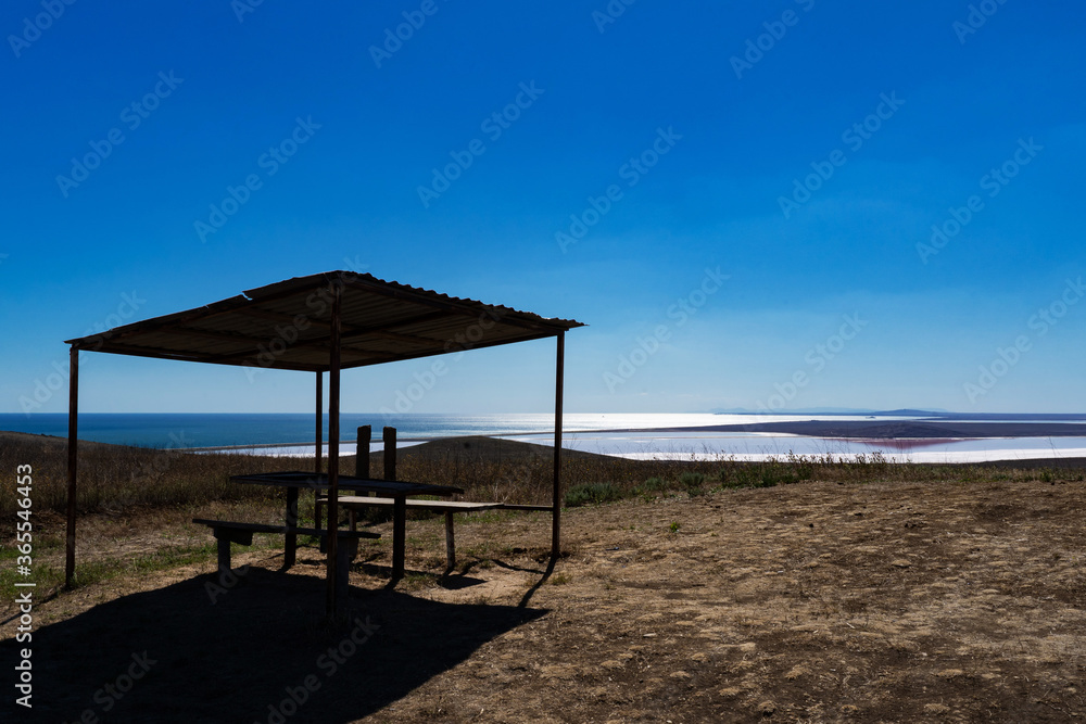 wooden gazebo in a field on the background of the lake and sea in Crimea wooden gazebo in a field on the background of the lake and sea in Crimea