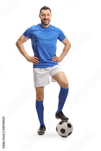Full length portrait of a cheerful soccer player posing with a ball © Ljupco Smokovski