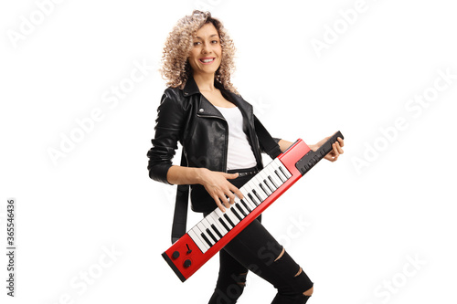 Female musician with a curly hair plaing on a red keytar