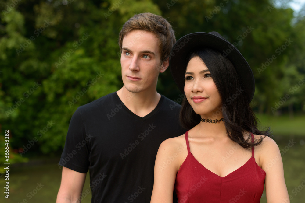 Portrait of multi ethnic couple together and in love at the park