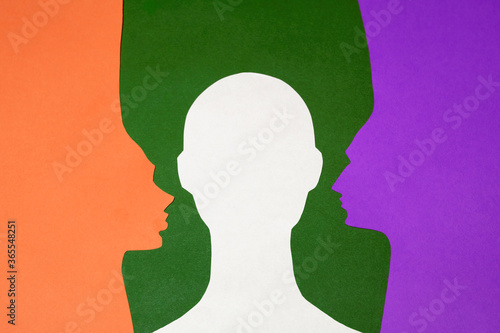The paper profiles and paper full face were cut out from orange, green, purple and white paper. The photo of paper art was shot flat lay for your craft design.