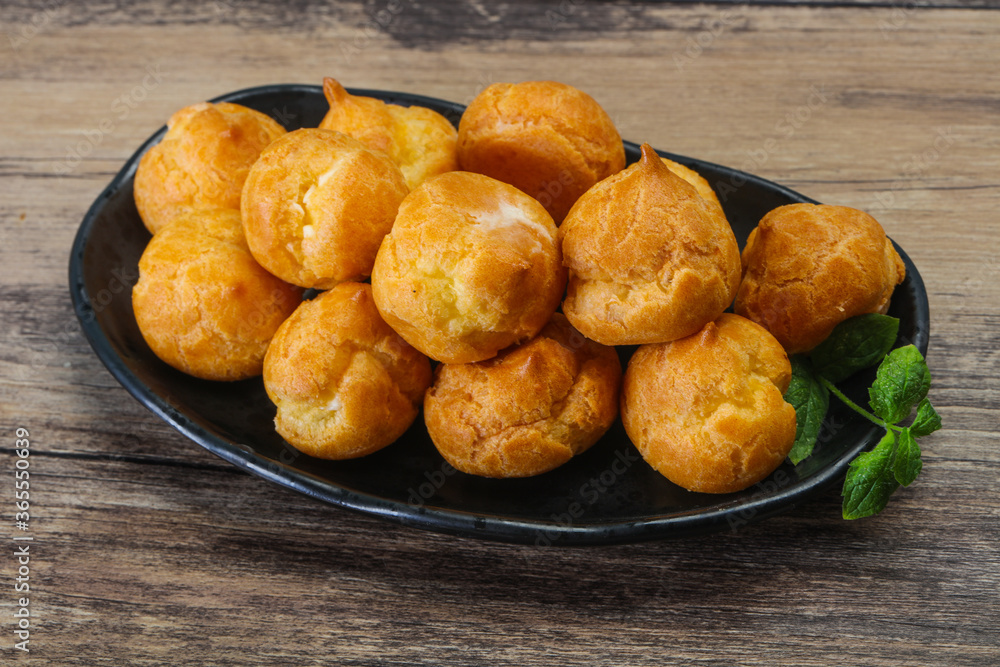 Sweet tasty profiteroles heap in the bowl Sweet tasty profiteroles heap in the bowl