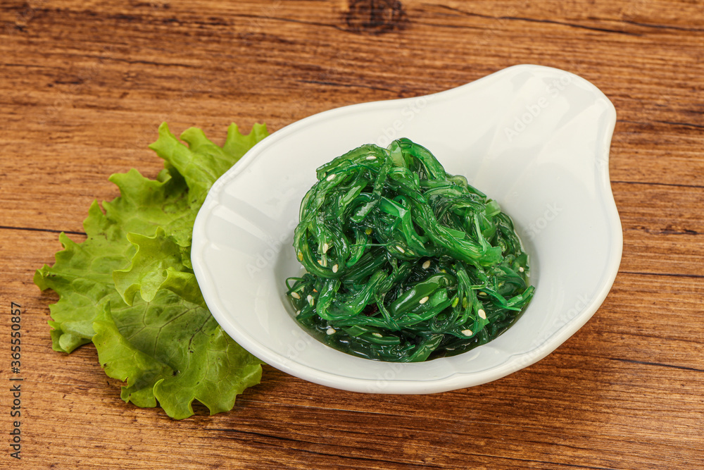 Green Chuka Seaweed Salad Isolated on White Background Top View. Wakame Sea Kelp Salat Green Chuka Seaweed Salad Isolated on White Background Top View. Wakame Sea Kelp Salat