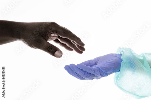 Hand of a black person trying to catch the doctor's