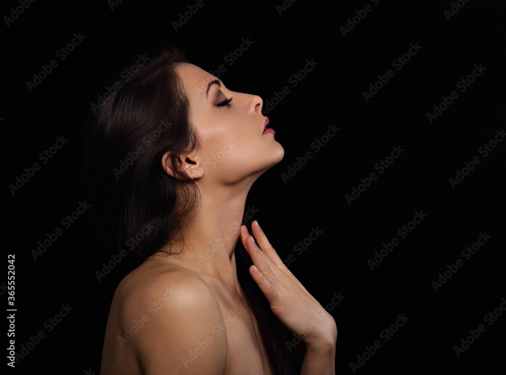 Beautiful makeup sexy woman touching the fingers elegant healthy neck skin wirh nude back and shoulder on black background with empty copy space. Closeup profile view portrait. Art Beautiful makeup sexy woman touching the fingers elegant healthy neck skin wirh nude back and shoulder on black background with empty copy space. Closeup profile view portrait. Art