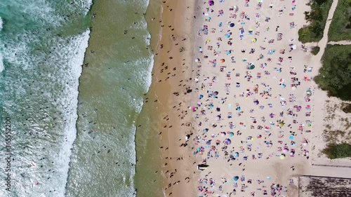 Aerial shot of the biscarrosse beach during the high summer season with lots of people crowded on the beach photo