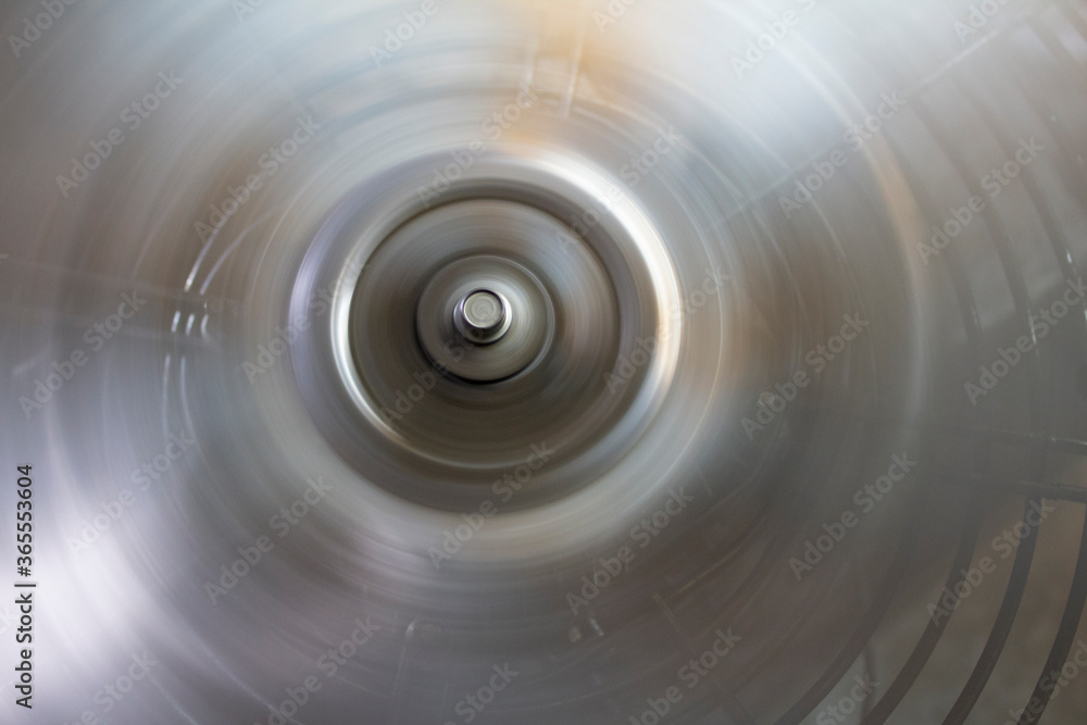 circle with a bolt head on the metal blades of a rotating fan. circle with a bolt head on the metal blades of a rotating fan.