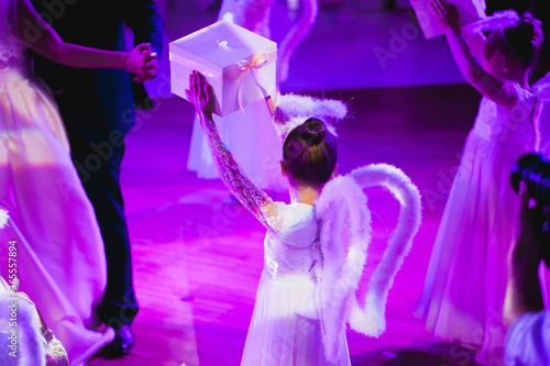 Little children dressed as an angel dancing at the wedding Banquet.