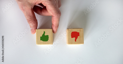 Hand making a choice between two cubes with 'Yes' and 'No' signs on white background. Business concept.