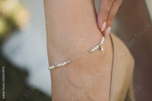 Jewelry on the bride's leg. photo
