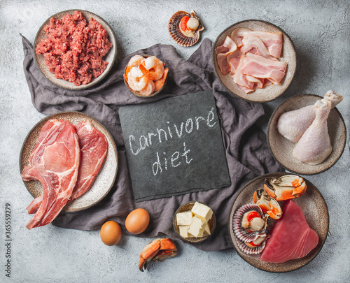 Carnivore diet concept. Raw ingredients for zero carb diet - fish, seafood, eggs, meat and animal fats. Top view or flat lay.