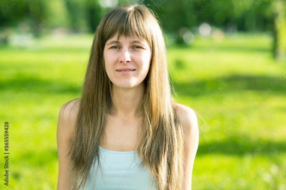 Portrait of pretty young woman in summer park. Portrait of pretty young woman in summer park.