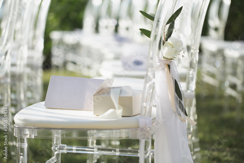 White transparent chairs at the wedding ceremony photo