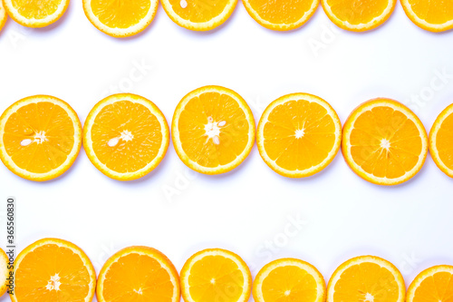 Flat lay view of orange slices on white backround.
