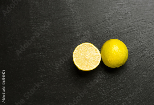 Close up of citrus lime fruits isolated on dark black background.