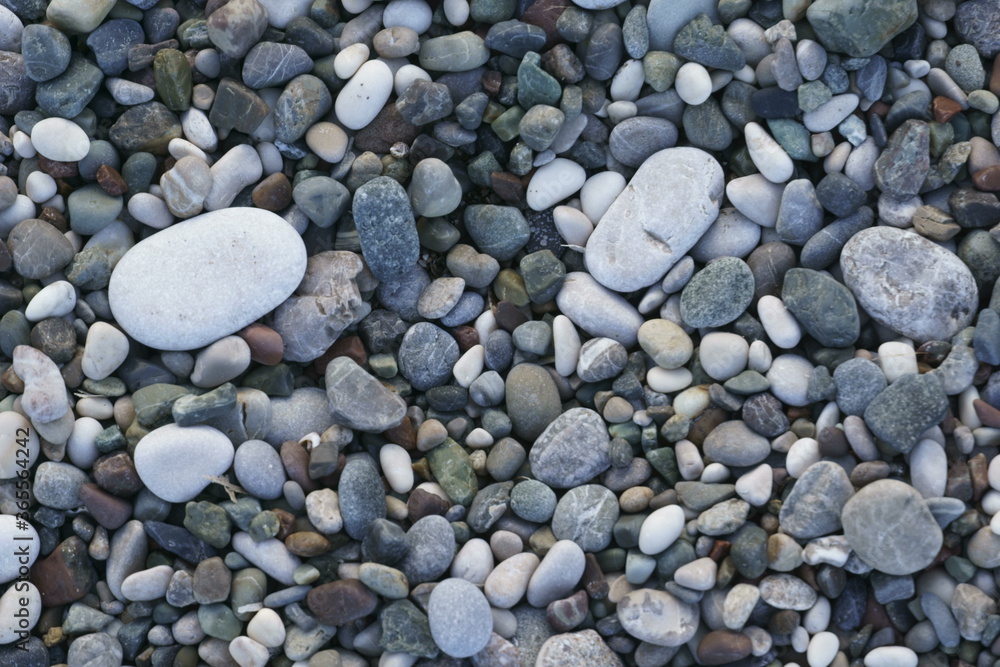 Closeup view of small stones on the beach with colorful pattern Closeup view of small stones on the beach with colorful pattern