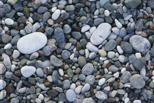 Closeup view of small stones on the beach with colorful pattern